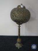 An Eastern brass table lamp with ball shade