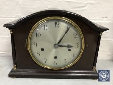 A mahogany cased mantel clock with pillar supports and silvered dial