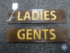 Two hand-painted wooden signs 'Ladies' and 'Gents'