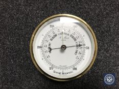 A brass cased circular barometer