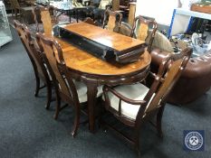 An oriental style oval extending dining table with two leaves,