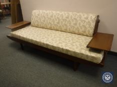 A mid 20th century Toothill teak day bed, with copper supports, fold out side tables and back rest,