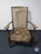 A 20th century bergere back armchair