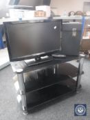 A Digihome 22 inch LED TV with remote and glass TV stand and a case of LP records