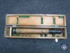 A military scope in a fitted wooden box