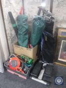 Two folding garden chairs, garden vacuum, electric hedge trimmer and a basket of hand tools,