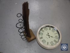 A driftwood and metal five bottle wine rack and a circular metal wall clock