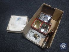 A box of two miniature copper and brass miner's lamps, brass vesta case, needlework handkerchiefs,