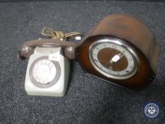 A two-tone vintage telephone and an oak cased mantel clock