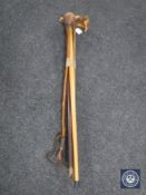 A bundle of four assorted walking sticks and an African club