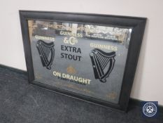 A contemporary framed overmantel mirror bearing Guinness advertising