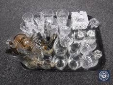 A tray containing assorted glass ware including drinking glasses, etched glass jug,