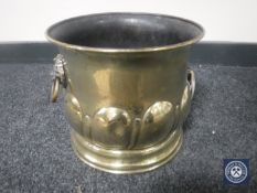 A brass coal bucket with lion mask handles