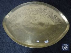 A large shaped brass etched tray