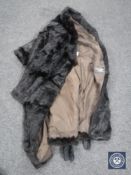 A lady's fur coat, dark brown, with belt.