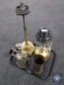 A tray containing an ammunition shell, lamp base, two vintage paraffin lamps,