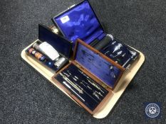 A tray of boxed instruments including Coronia razor, drawing utensils,