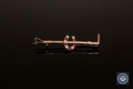 A diamond and garnet set riding crop/horseshoe brooch CONDITION REPORT: 3.