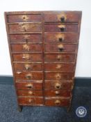 An antique pine twenty drawer chest containing threads and buttons