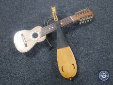 A tourist armadillo-backed mandolin with mother of pearl inlay,