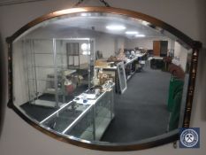 A copper framed Arts & Crafts bevelled edged mirror