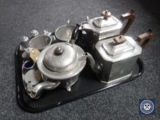 A tray containing early 20th century pewter ware including four-piece craftsmen pewter tea service,