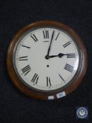 A circular oak cased school clock