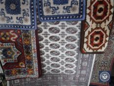 Four 20th century woollen rugs and two machine made Persian style rugs