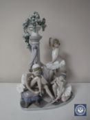 A Lladro figure group of three ballerinas around a column,