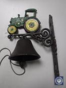 A cast iron tractor wall bracket with bell