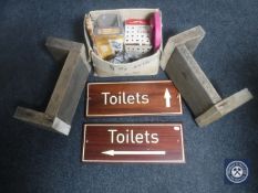 Two wooden toilet signs, two wooden crackets and a box containing metal coat hooks, card shuffler,