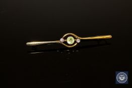 A 15ct gold peridot and diamond bar brooch