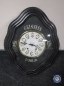 A late 19th century continental wall clock with gilt and enamelled dial bearing Guinness