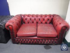 A red button leather two seater Chesterfield settee
