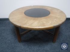 A circular teak G-Plan coffee table with a smoked glass insert
