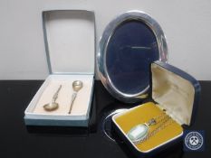 An oval silver photo frame, a Wedgwood pendant on silver chain,