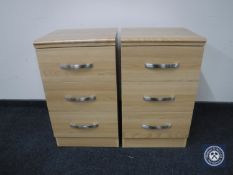 A pair of three drawer bedside chests