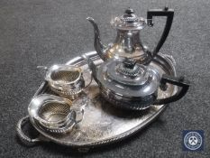 A silver plated twin-handled gallery tray on paw feet and a four-piece Sheffield plate tea service