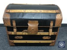 An early 20th century oak and leather bound domed topped trunk