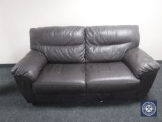 A brown leather two-seater settee