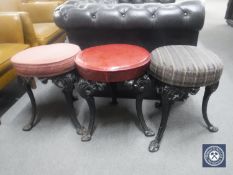 Three circular bar stools on cast iron legs