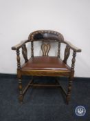 An early 20th century oak leather upholstered desk chair