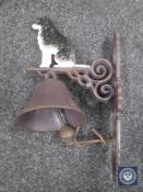 A cast iron border collie wall bracket with bell