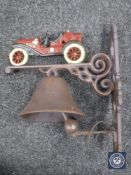 A cast metal vintage car wall bracket with bell