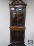 A Victorian inlaid mahogany corner cabinet with astral glazed doors