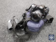 A Minolta Dynax 500 SI camera with lens in carry bag,
