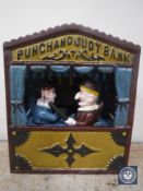 A cast metal Punch and Judy metal money box