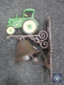 A cast metal tractor wall bracket with bell