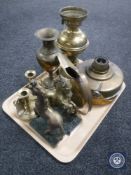 A tray of assorted brass ware including a converted oil lamp, stove candlesticks,