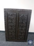 A 19th century profusely carved corner cabinet